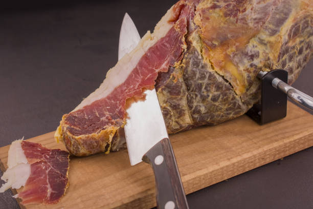 istock Serrano ham leg shoulder on its wooden base ready to be cut 1439252773