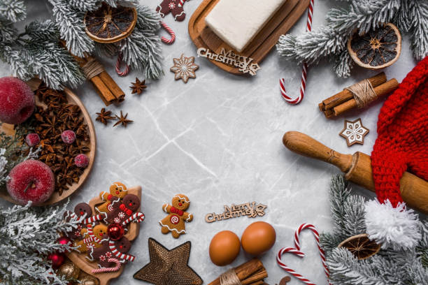 istock Happy New Year 2023. Banner with kitchen utensils, Christmas decorations, cinnamon, gingerbread and spruce on a marble background. A greeting card for Christmas. The concept of cafes and restaurants. 1439254023