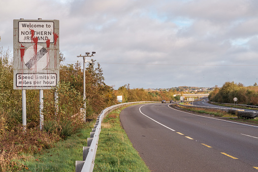 Killeen, Northern Ireland, UK - October 30, 2022: Roadside sign welcoming visitors travelling on the N1 from the Republic of Ireland and entering into Northern Ireland on the A1 near Newry (County Down).