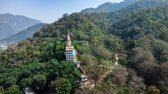 hindu ancient temple nestled in dense green forest at morning image is taken at bhutnath temple rishikesh uttrakhand india on Mar 15 2022.