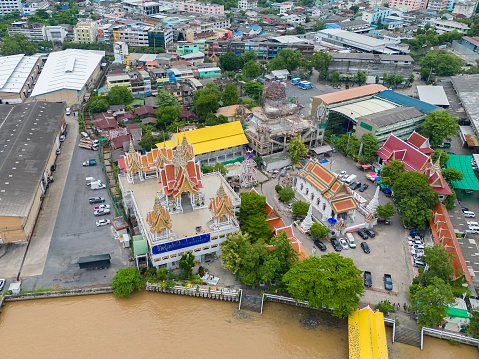 Aerial view of Bang Khun Thian Canal with nature trees, Wutthakat district, Bangkok City, Thailand in urban city in Asia. Residential houses, buildings at noon.