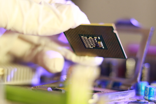 Microprocessor Socket. Shop Technician Installing Cpu Chip Microprocessor Socket On Motherboard ...