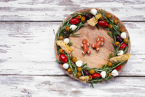 Christmas wreath appetizer board over white wood