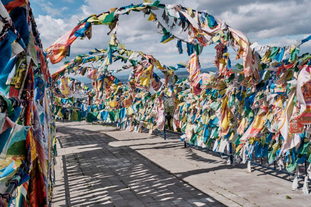 Buddhist prayer flags with mantras. Buddhist datsan Rinpoche Bagsha, Ulan-Ude,Buryatia, Russia Flags of good luck,buddhist prayer flags with mantras on special metal structures, fluttering in wind. Buddhist datsan Rinpoche Bagsha on mount Lysaya, Ulan-Ude, Buryatia, Russia siberian flag stock pictures, royalty-free photos & images