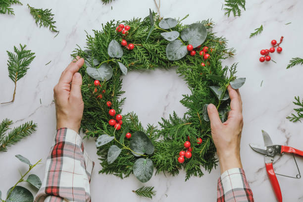 istock Hands holds DIY Christmas wreath. 1439269037