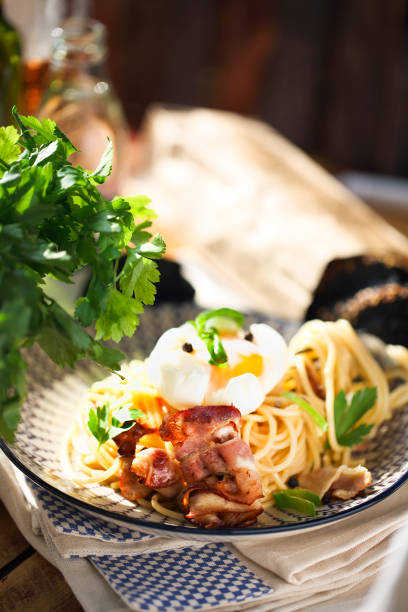 istock Nicely served spaghetti carbonara on black background 1439271881