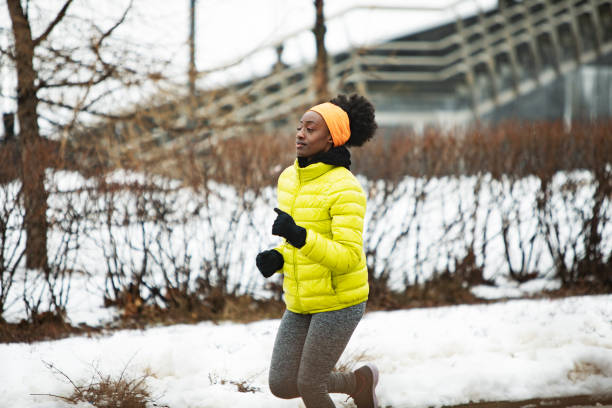 istock Young African woman training outdoors in bad weather 1439272753