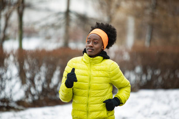 istock Young African woman training outdoors in bad weather 1439272806