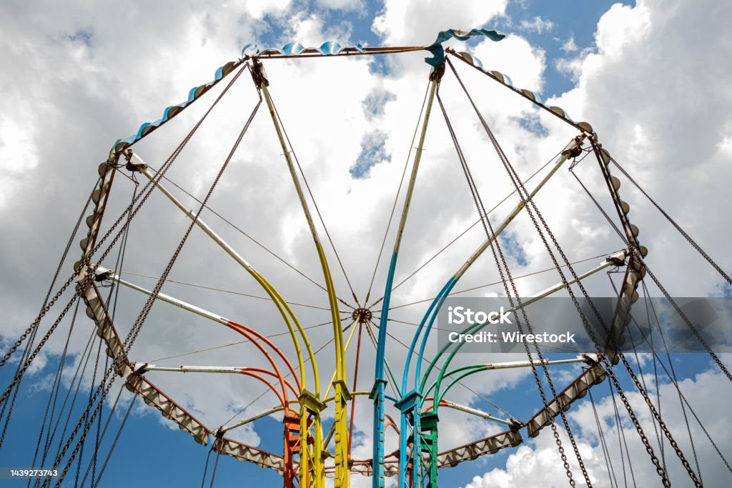 Low angle shot of a colorful turning carousel ride under a bright sky in Gyumri, Leninakan, Armenia A low angle shot of a colorful turning carousel ride under a bright sky in Gyumri, Leninakan, Armenia Arts Culture and Entertainment Stock Photo