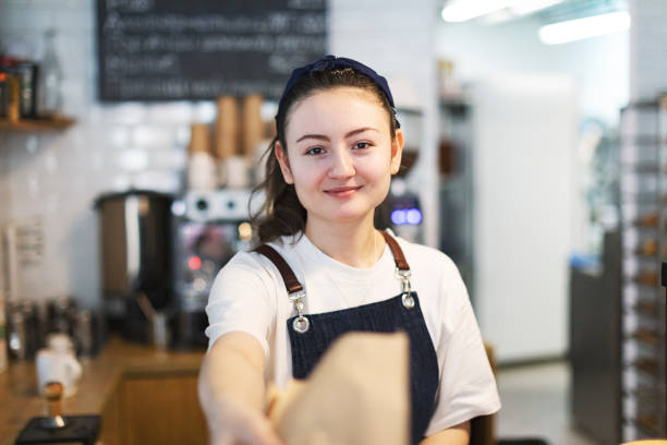 istock Waiter selling fresh bread at cafe 1439277130