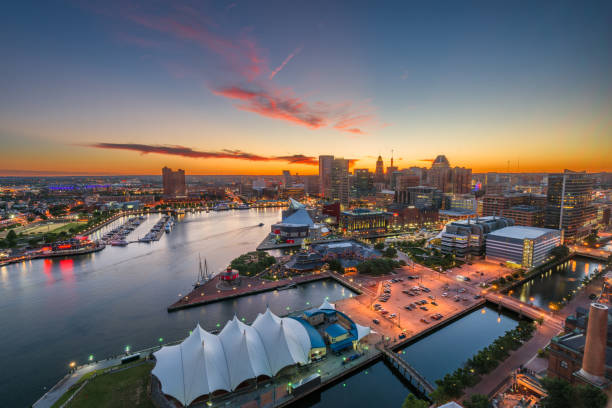 Baltimore, Maryland, USA Skyline Looking Over the Inner Harbor Baltimore, Maryland, USA Skyline on the Inner Harbor at dusk. baltimore maryland stock pictures, royalty-free photos & images