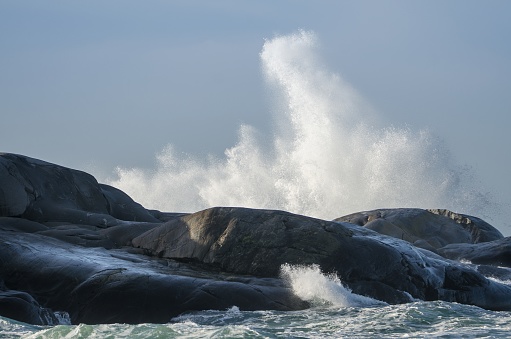 Waves hit on the cliffs on a windy day by the sea on Sweden's west coast, Öckerö, the northern archipelago of Gothenburg.