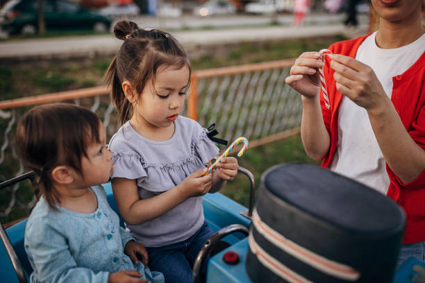 istock Family in amusement park 1439279041