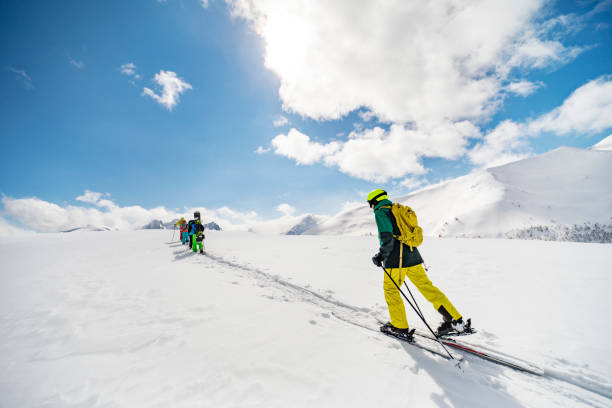 istock Group of people going off piste in mountains 1439279046