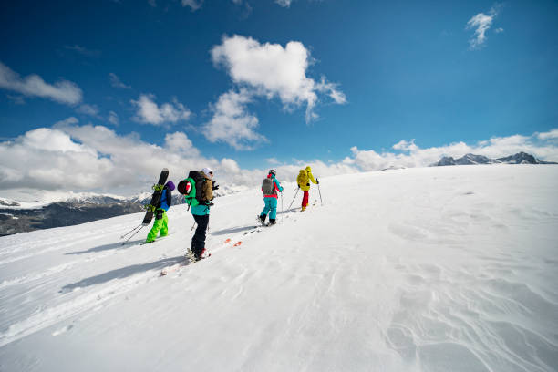 Group of people going off piste in mountains stock photo