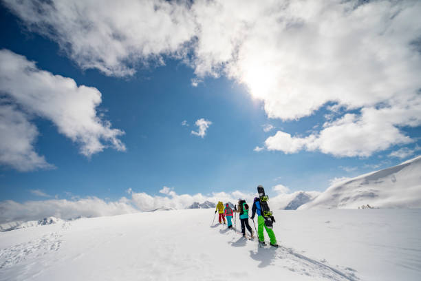 istock Group of people going off piste in mountains 1439279189