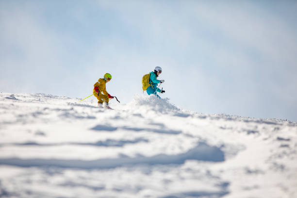 istock Mother with son skiing in mountains at ski resort 1439279263