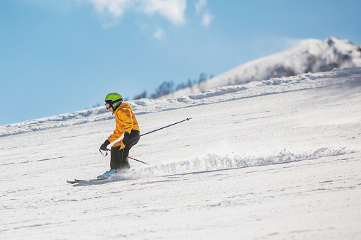 Boy skiing in mountains at ski resort