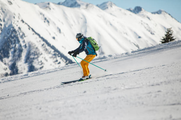 istock Young man skiing in mountains at ski resort 1439279342