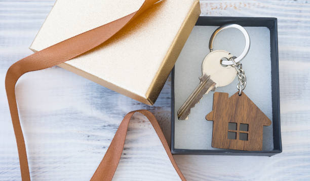 istock Gift box with a key to the house or apartment 1439279492