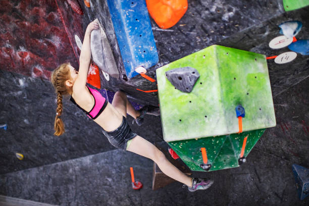 istock Little girl climbing on rock-climbing wall 1439280738