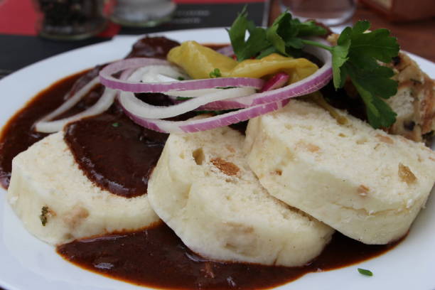 Czech Republic - Prague - Knedliky with goulasch ( Knedliky are not a dish in the strict sense as we can hear. These are bread or potato dumplings made from flour, eggs, yeast and stale bread, often presented in the form of thick slices resembling slices of white bread)