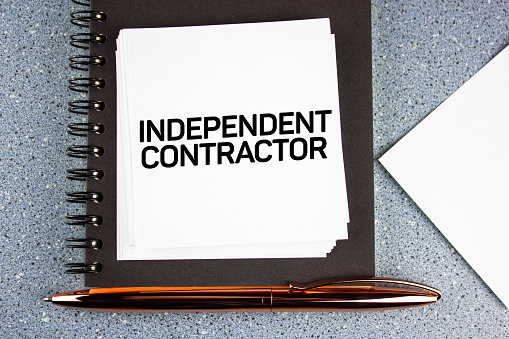 The independent contractor - quote text on office desk. Business concept.
