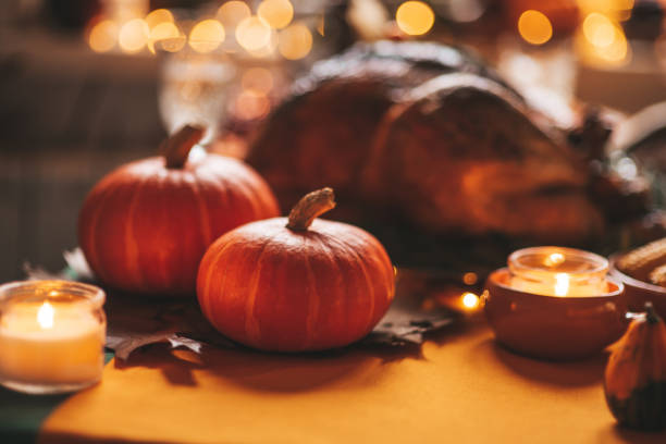 istock Thanksgiving holiday dinner table setting with fall decoration and pumpkins 1439286678