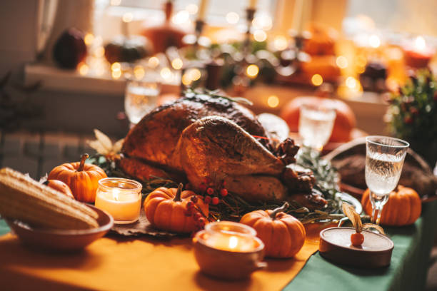 istock Thanksgiving holiday dinner table setting with fall decoration and pumpkins 1439286684