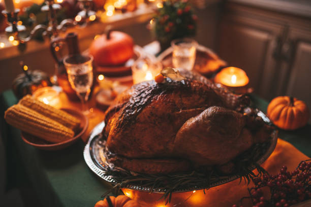 istock Thanksgiving holiday dinner table setting with fall decoration and pumpkins 1439286694