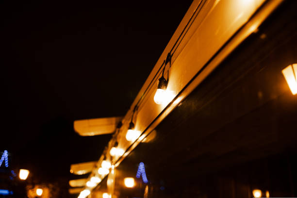 istock Blurred image of the cafe terrace interior with garland lights. Abstract image. 1439287704