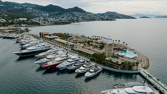 April 30, 2023: This photo shows the glamorous and luxurious principality of Monaco, nestled on the stunning French Riviera. The image captures a panoramic view of the cityscape, featuring the towering hillside, opulent architecture, and the Mediterranean Sea. The photo is also adorned with the yachts moored in the harbor.