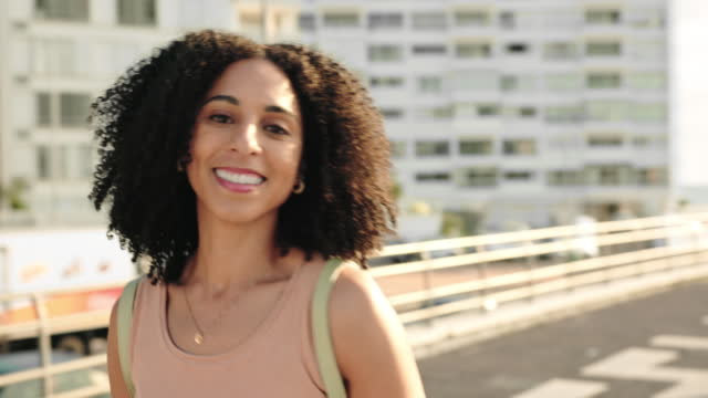 Brazilian woman, fashion or city travel on Rio de Janeiro building rooftop for summer holiday. Portrait, smile or happy student or tourist with backpack, afro or trendy style clothes in handheld view