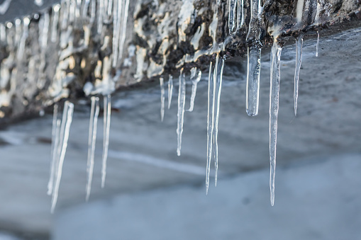 Icicles hang on the roof. Winter background. Weather. Climate