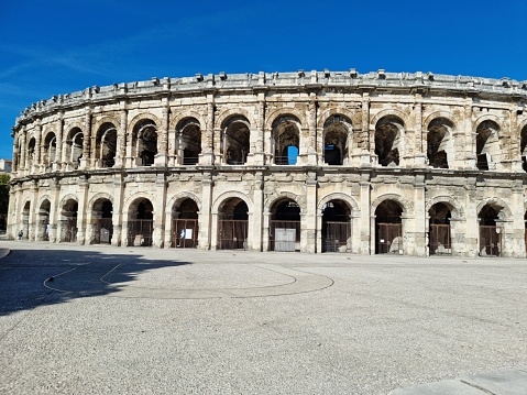 The Arena of Nîmes is a Roman amphitheatre, situated in the French city of Nîmes. Built around 70 CE, shortly after the Colosseum of Rome, it is one of the best-preserved Roman amphitheatres in the world. The image was captured during autumn season.