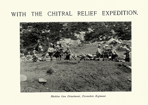 Vintage illustration after a photograph Machine gun detachment of Devonshire regiment during the Chitral Expedition 1895, British Imperial military history. The Chitral Expedition was a military expedition in 1895 sent by the British authorities to relieve the fort at Chitral, which was under siege after a local coup following the death of the old ruler. An intervening British force of about 400 men was besieged in the fort until it was relieved by two expeditions