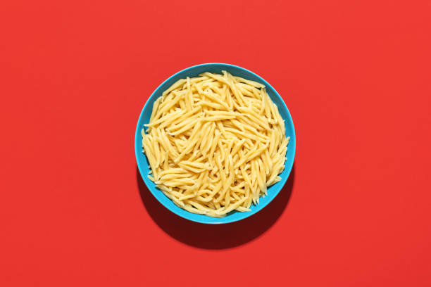 istock Trofie pasta bowl top view on a red background 1439300989