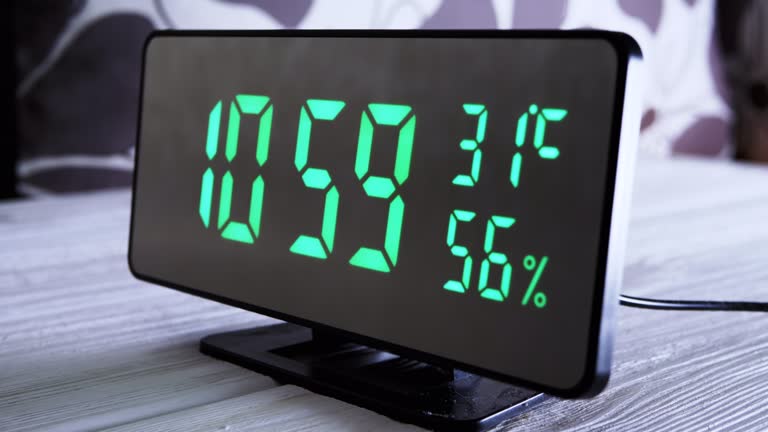 Digital Clock Showing Time on Green Display 10:59 AM, Temperature, Air Humidity