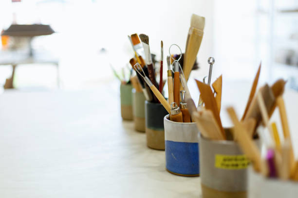 Spatulas for molding ceramics Spatulas for molding ceramics in clay cups in a studio homemade pottery wheel stock pictures, royalty-free photos & images