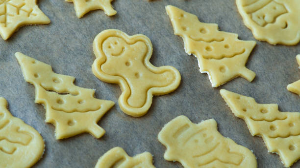 istock Raw homemade Christmas tree and gingerbread man shaped butter cookies biscuits 1439311161