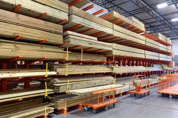 Warehouse with variety of timber for construction and repair on pallets on storage shelves. stock photo