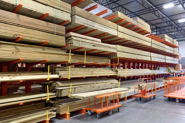 Warehouse with variety of timber for construction and repair on pallets on storage shelves. Warehouse with variety of timber for construction and repair on pallets on storage shelves. The factory for the production of laminate. Stacked wood pressboard stock pictures, royalty-free photos & images