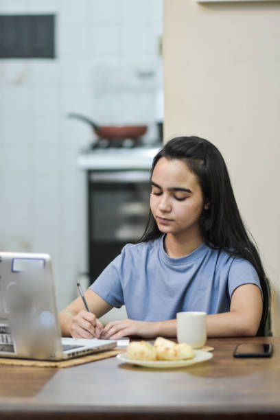 istock Young girl uses the computer to pay the bills 1439312551