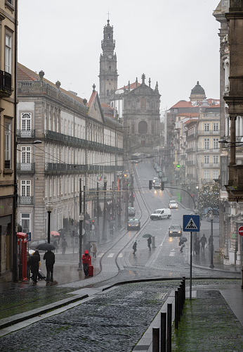 Calle Rua 31 de Janeiro, Iglesia de los Clérigos y Torre de los Clérigos en un día lluvioso - Oporto, Portugal photo