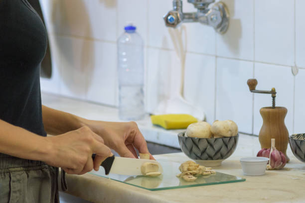 Young girl cutting mushrooms