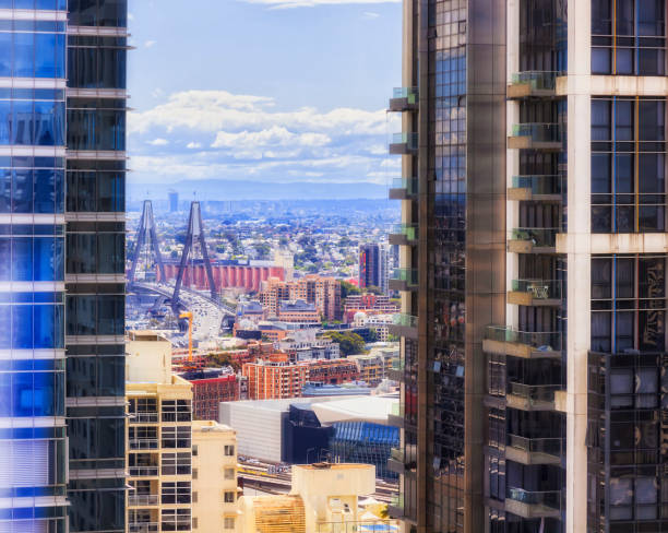 Toll high-rise residential towers in Sydney city CBD - view to distant Anzac bridge and Inner West suburbs of downtown Sydney.