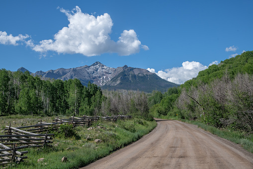 Dirt road near Telluride through San Juan Mountains of southwestern Colorado, USA.