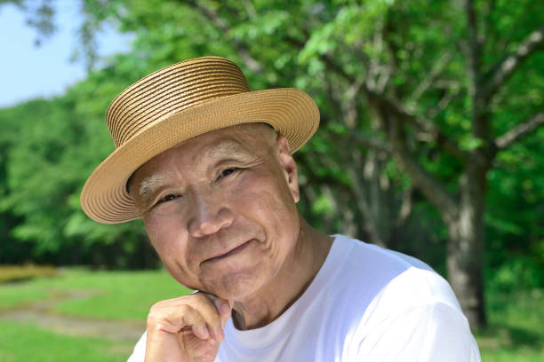 istock Smiling senior man relaxing in the park 1439318821