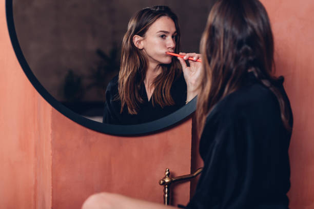 istock Young woman brushes her teeth before going to sleep 1439326420