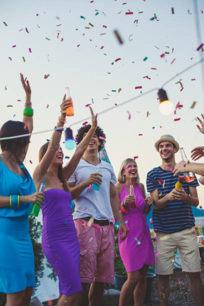 istock Friends and confetti for a rooftop party 1439326495